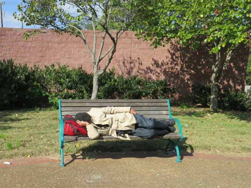 Homeless person laying on a bench in Nashville, TN