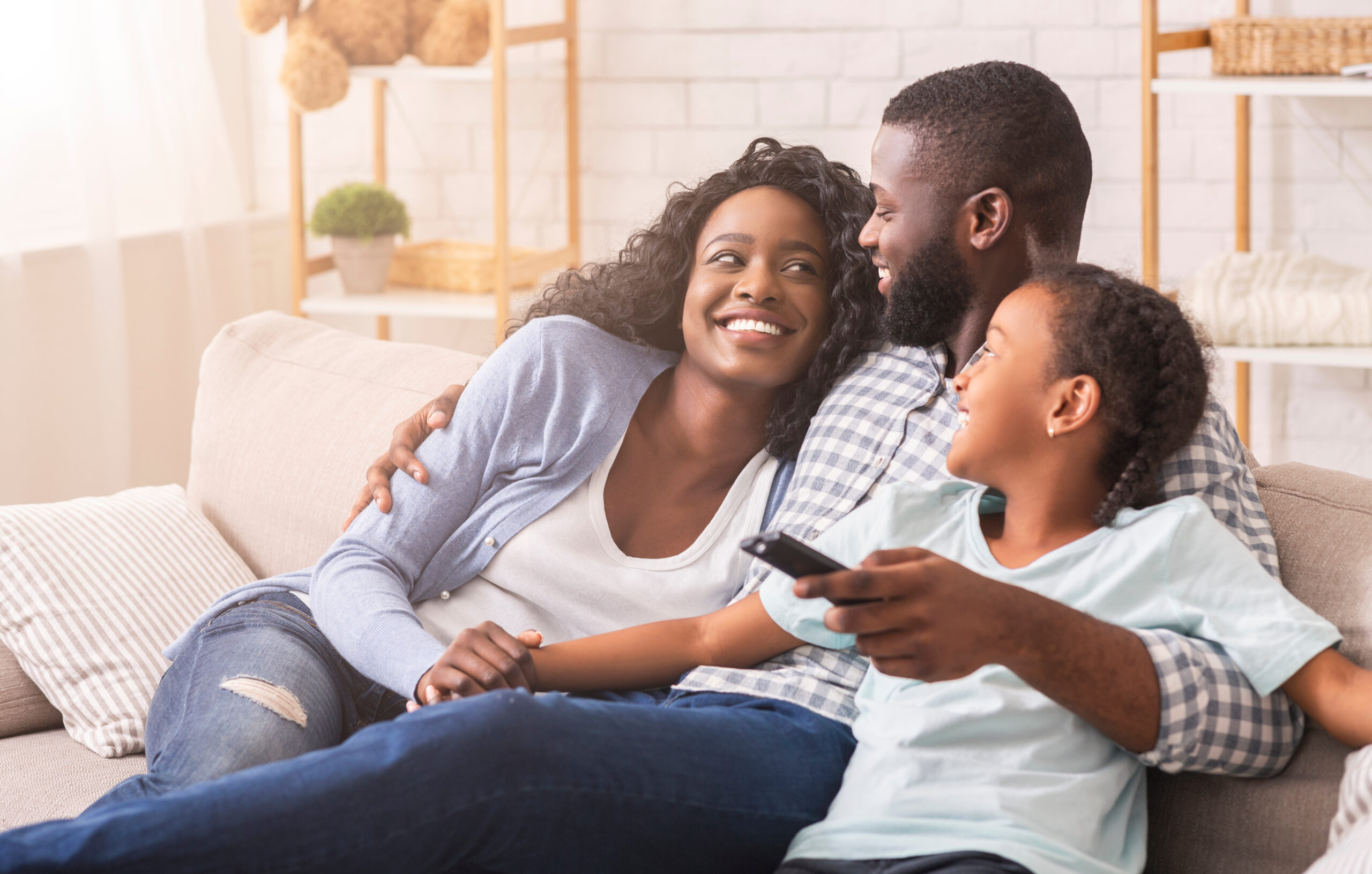 Photo of Cheerful Black Family Having Fun Together Watching TV Show