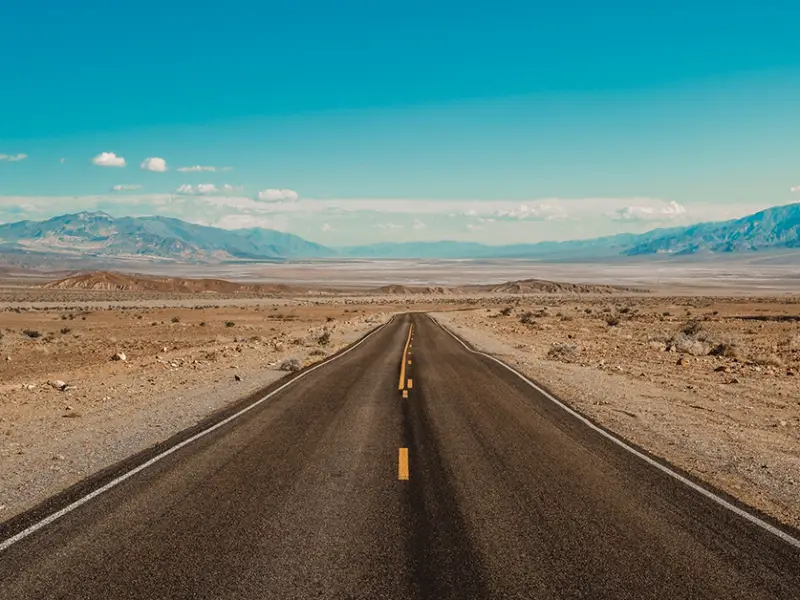 Photo of empty desert road during the day - Photo by Adobe Stock