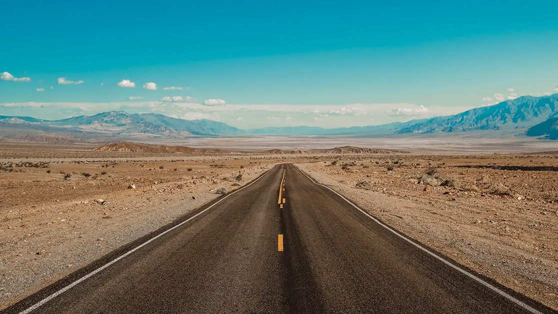 Photo of empty desert road during the day - Photo by Adobe Stock