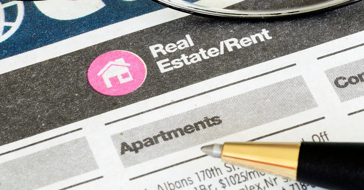 Photo of a newspaper's classifieds page showing apartment listings for rent. Photo by Adobe Stock.